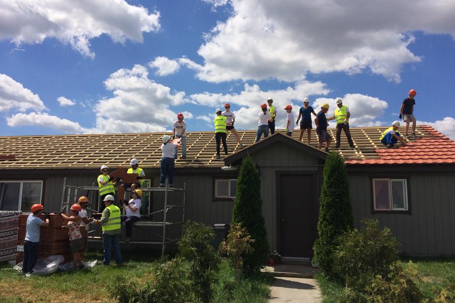 Building Humanity volunteers roofing a home in Romania